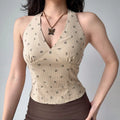 Closeup light beige ribbed halter cropped tank, tiny dark cherry pattern v neck bust pleated bodycon summer cami