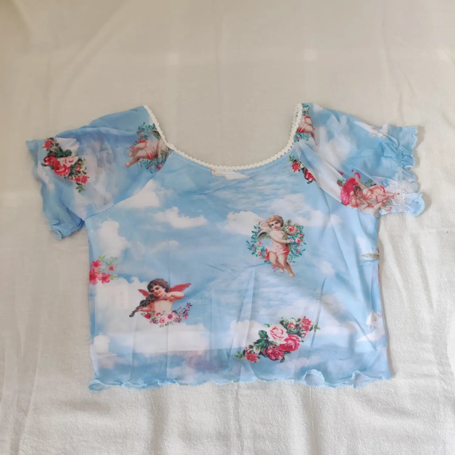 Flat lay back view light blue sheer mesh crop top with full cherub and rose floral print