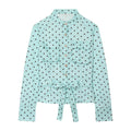 Front flat product shot light blue brown polka dot blouse, mandarin stand collar, front patch pockets, shell buttons, matching waist tie belt, cropped fitted silhouette