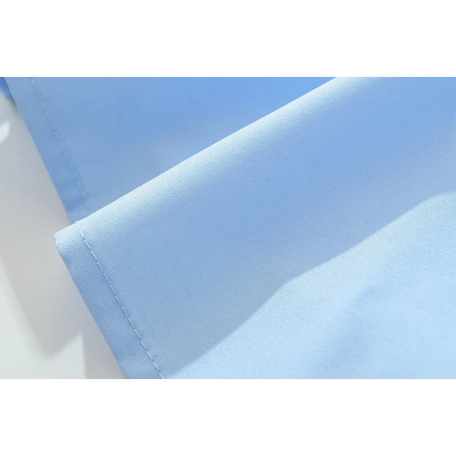 Close‑up finished hem stitching and smooth skirt fabric light blue halter lace maxi dress