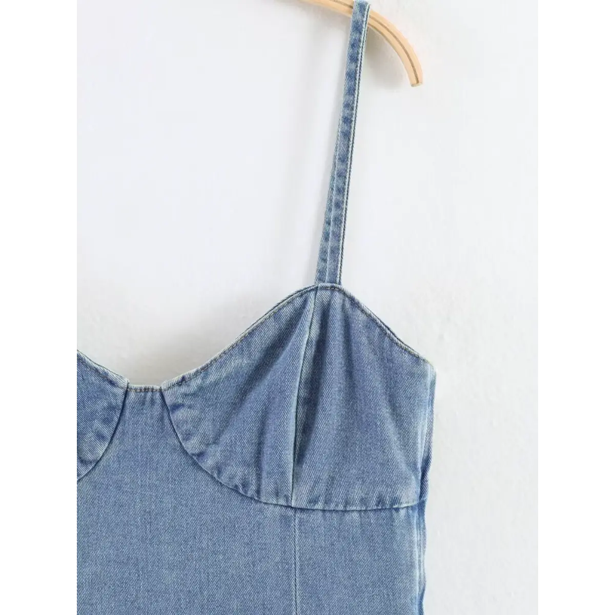 Close-up of the spaghetti straps and sweetheart neckline on the light blue denim cami dress