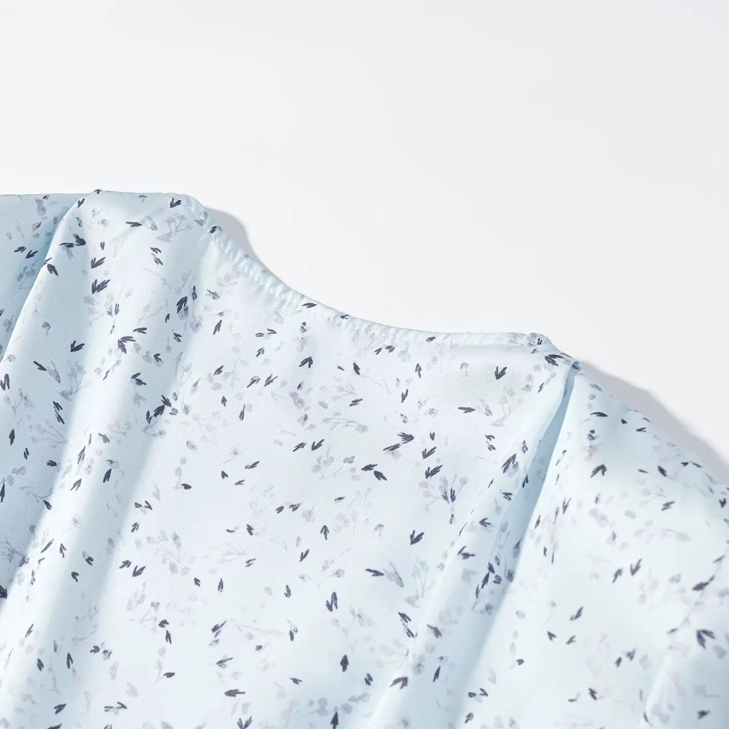 Close‑up shoulder seam and fabric texture light blue ditsy floral print maxi dress