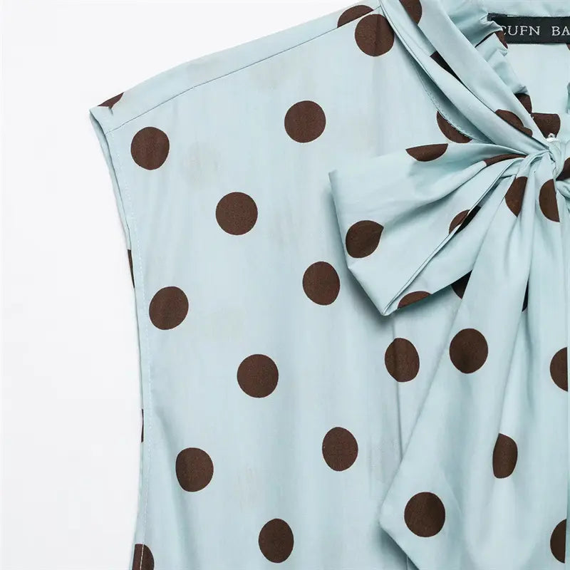 Sleeveless armhole seam closeup, clean finished edge, polka dot printed fabric
