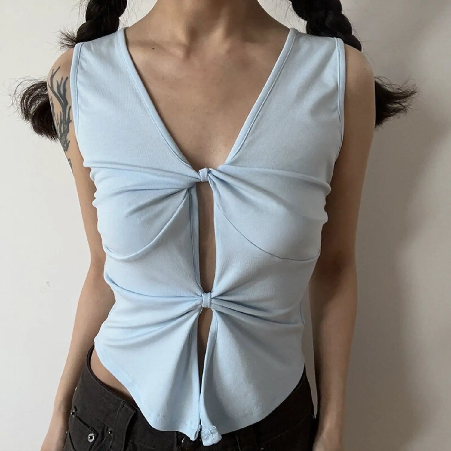 Light blue double knot v-neck sleeveless top half body indoor shot, double layer twist cutout slim waist cropped fit, double braid girly soft fresh styling