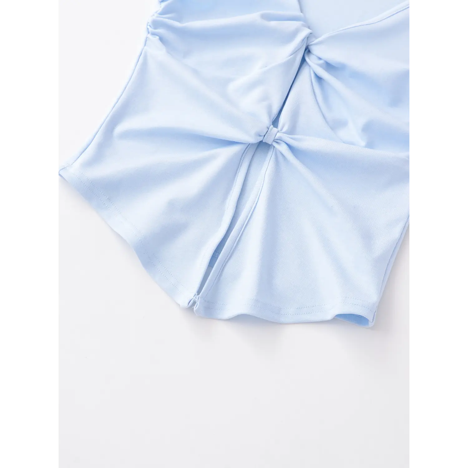 Light blue double knot sleeveless tank hem macro flat close-up, double twist fixed stitching high stretch knit texture split hem overlock detail white background shot