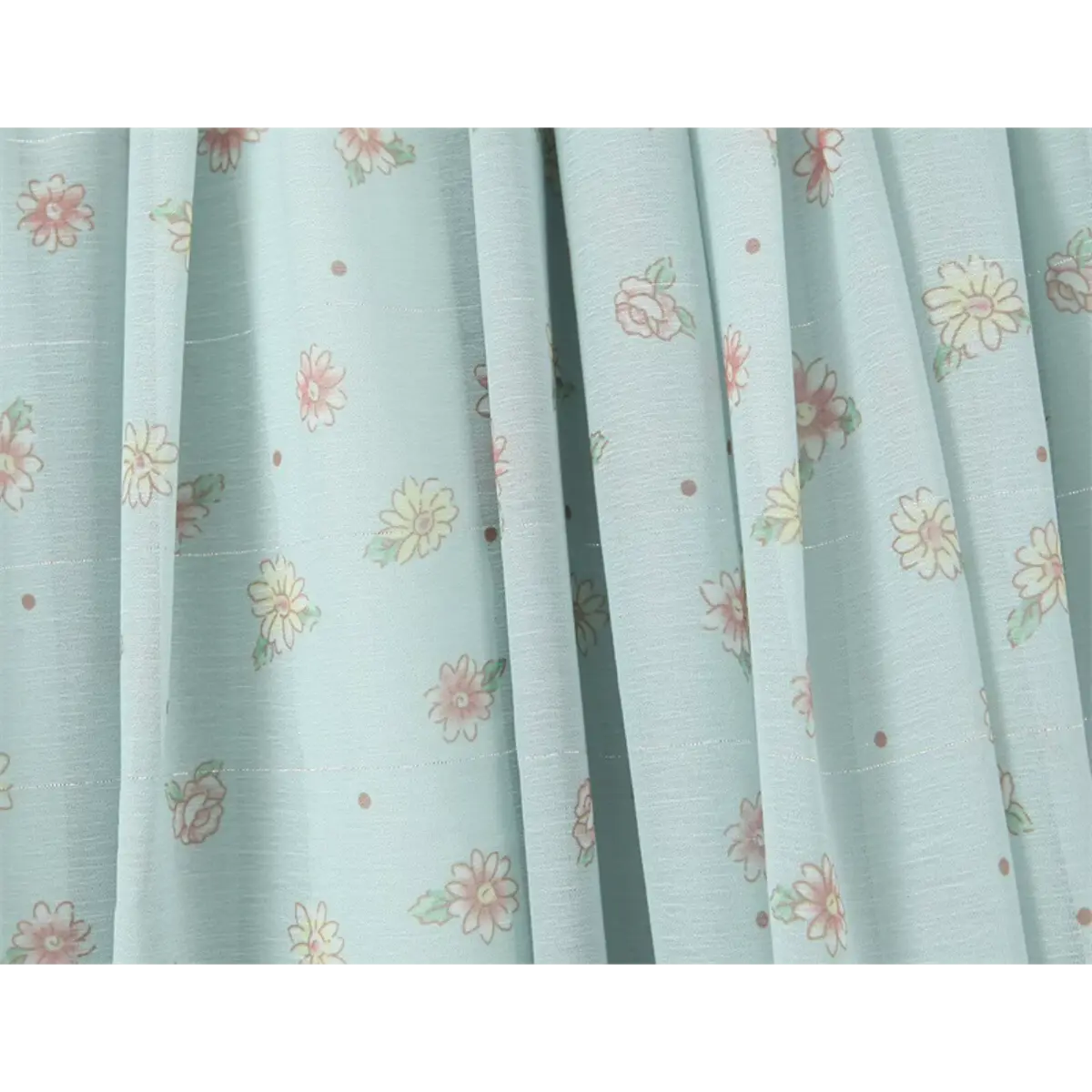 Close-up of the delicate floral print and lightweight fabric texture on the light blue dress