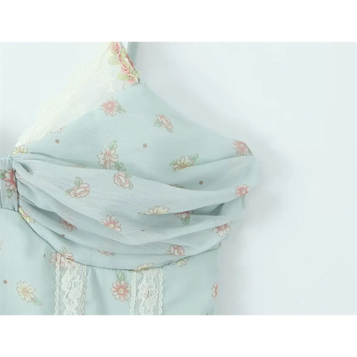 Close-up of the sweetheart neckline and gathered bust on the light blue floral cami dress