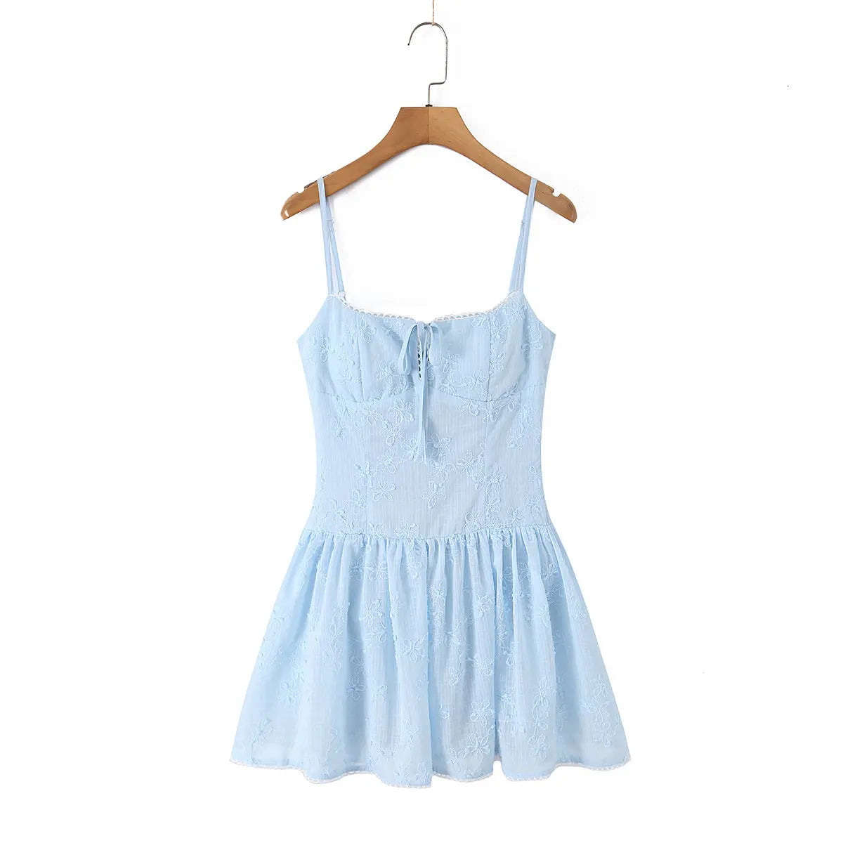  Front view of a light blue spaghetti strap dress with floral embroidery, hanging on a wooden hanger.