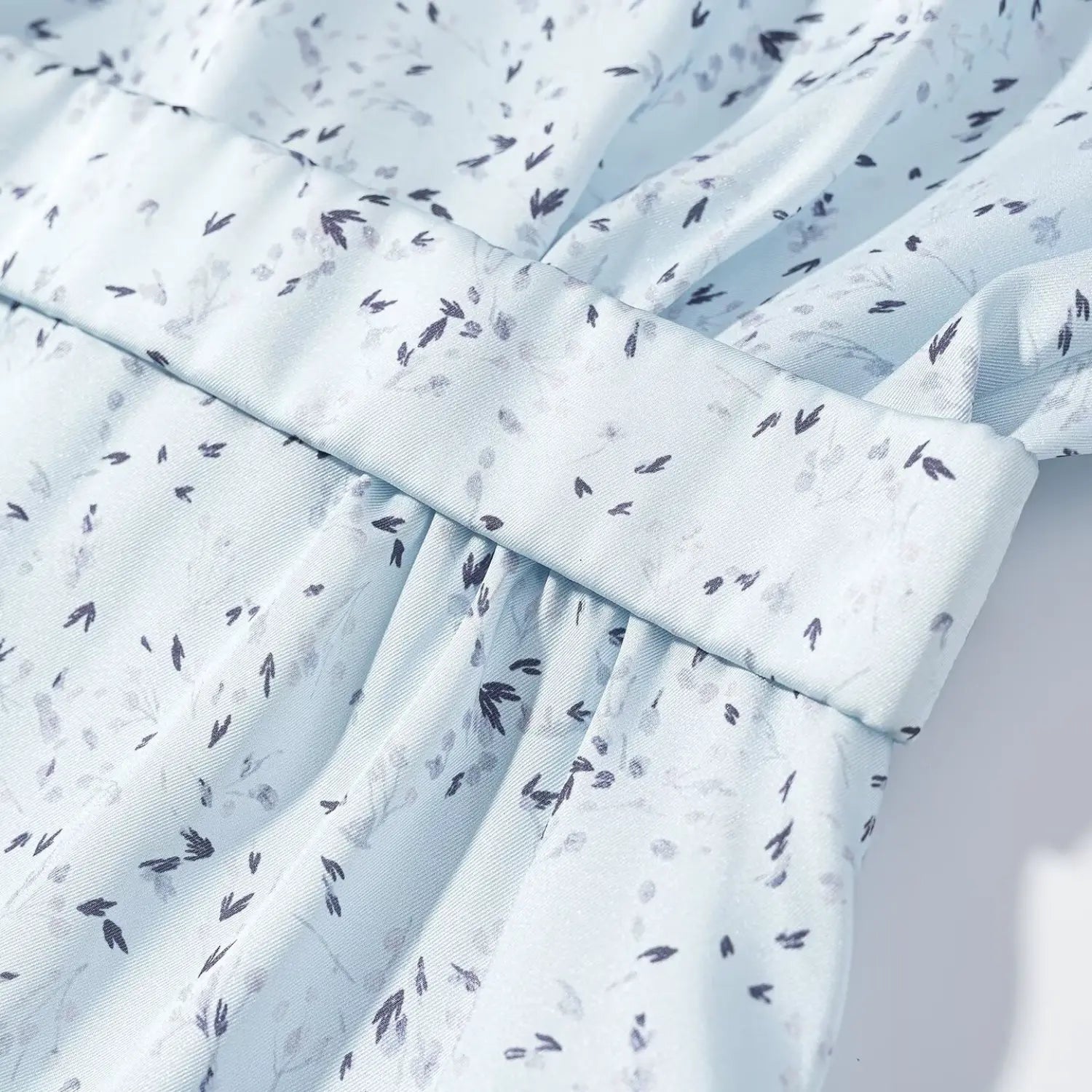 Close‑up waist belt loop and pleated gathering construction light blue ditsy floral maxi dress