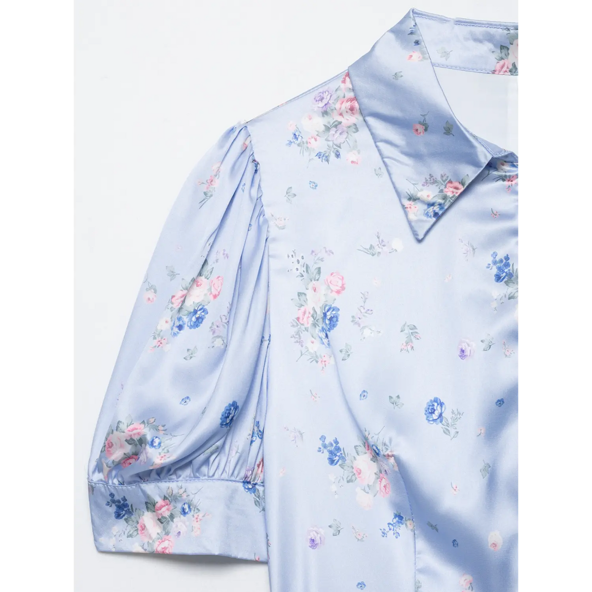Close-up of light blue floral maxi dress lapel collar and puff sleeve, shiny satin fabric, mixed pink blue rose floral print