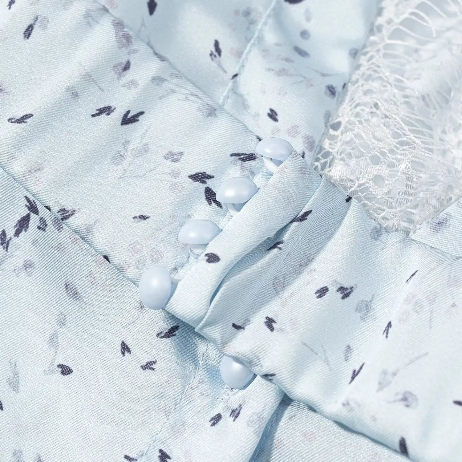 Extreme close‑up front decorative round button placket detail light blue floral maxi dress