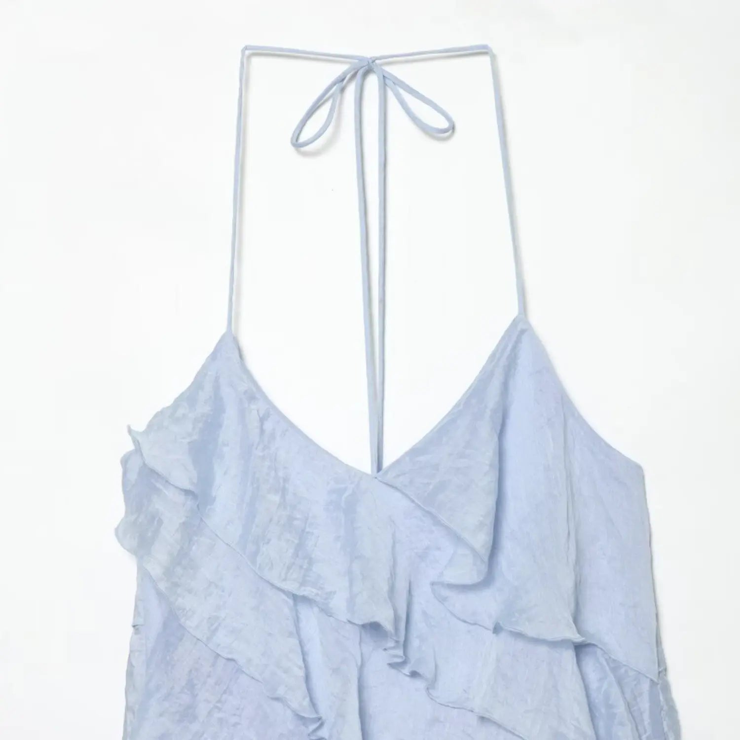 Partial close-up of pale blue halter dress front, deep v neckline, overlapping diagonal waterfall ruffle trim, wrinkled glossy woven texture