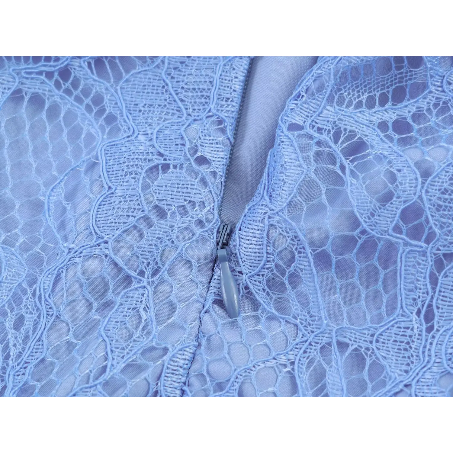 Macro detail of matching invisible back zipper sewn into floral lace dress
