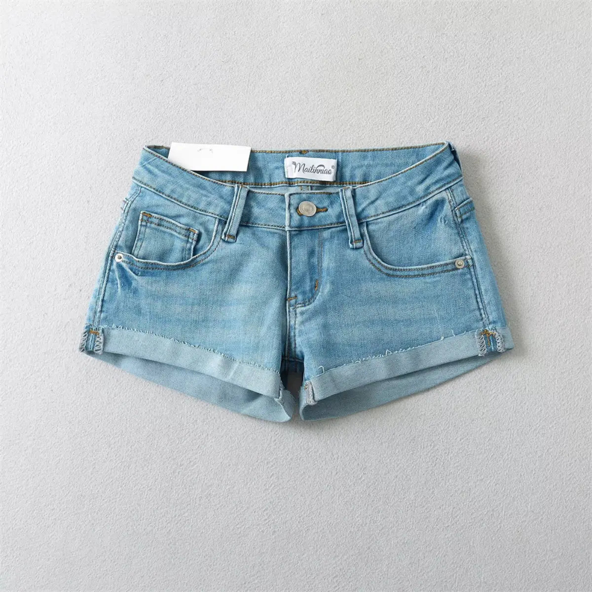Light blue low-rise denim shorts with rolled cuffs, shown from the front flat view.
