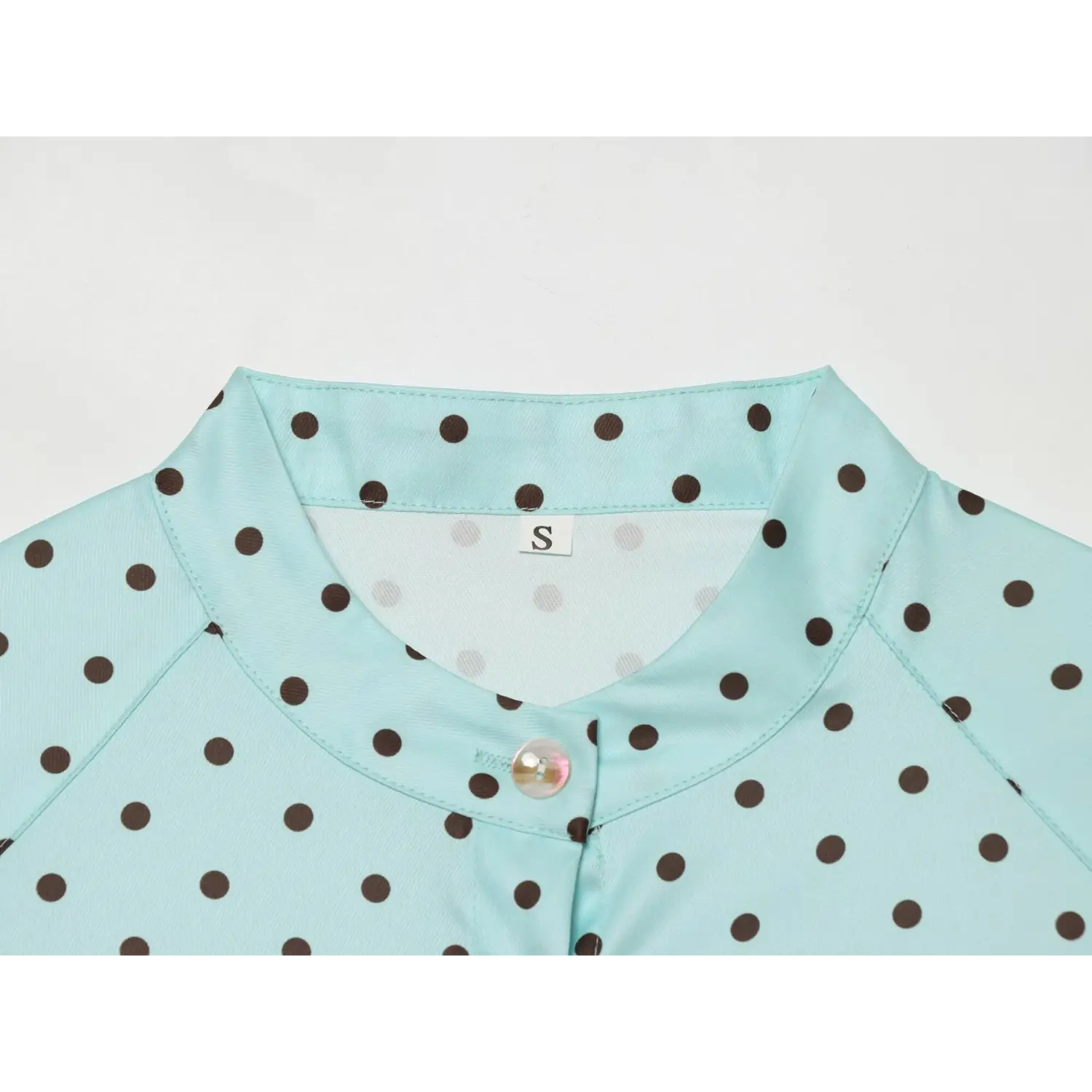 Detail neat constructed stand collar, inner woven size label, raglan shoulder stitching