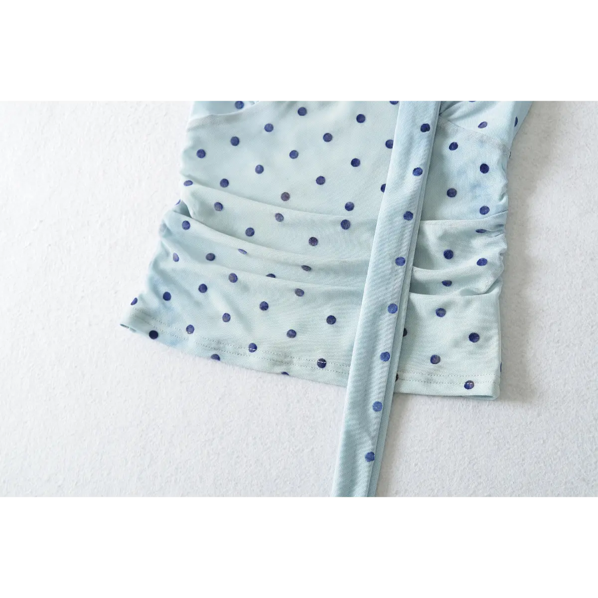 Close-up of the side ruched detail, showcasing the stretch mesh construction and soft texture.