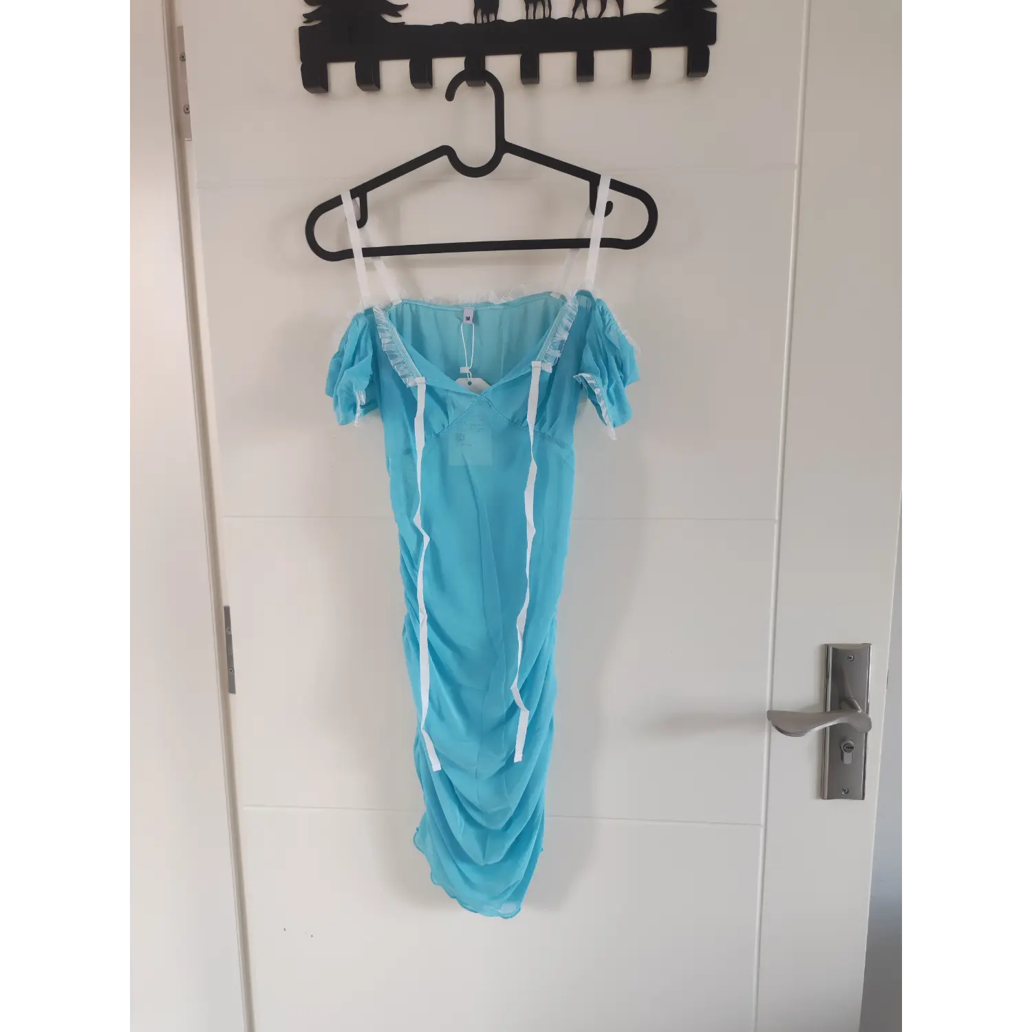 Front view of light blue sheer mesh off shoulder bodycon dress, white frill trim, bubble short sleeves, white ribbon straps, ruched mini skirt, M size women outfit