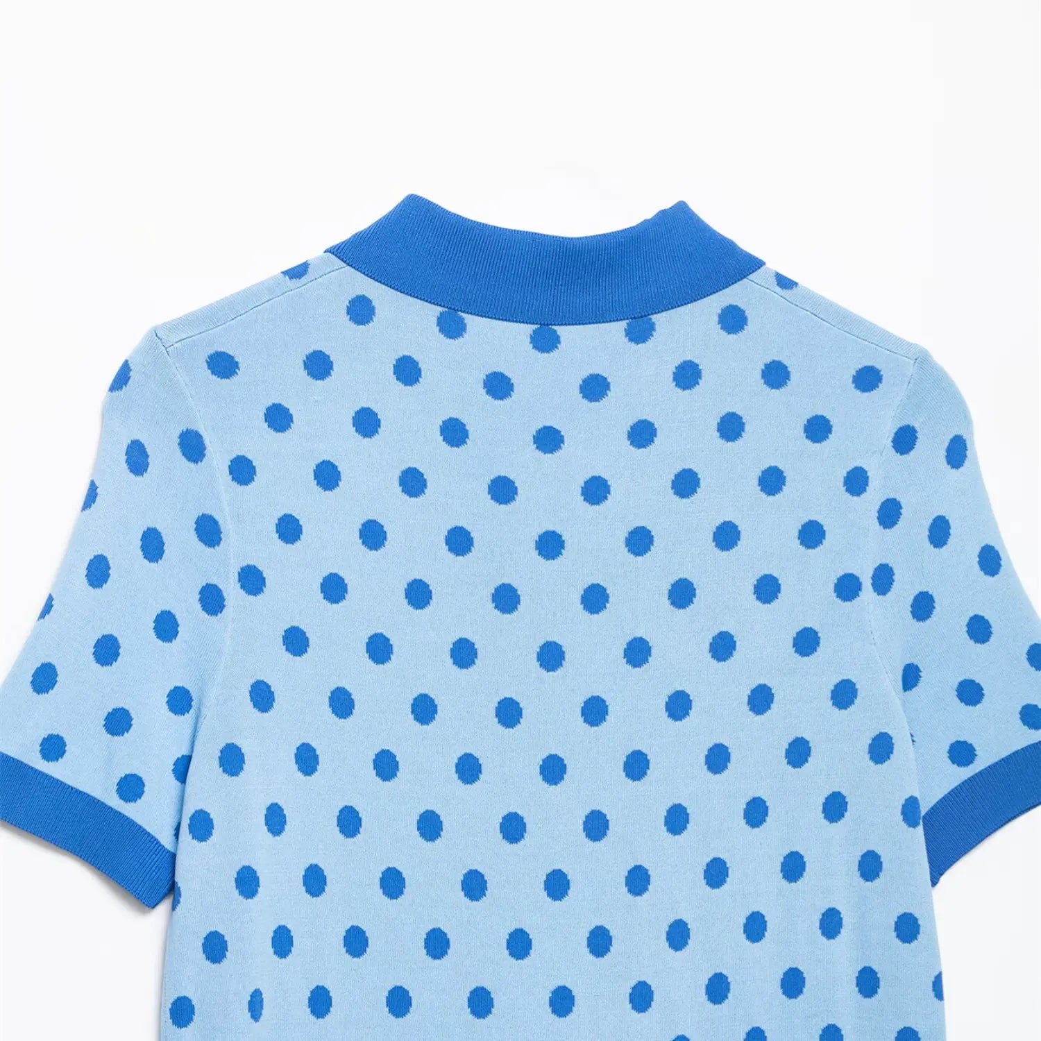  Close-up of the ribbed back collar on the light blue polka dot knit polo top
