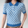 Lifestyle shot of model wearing the light blue polka dot polo knit top, showing the full silhouette and color contrast