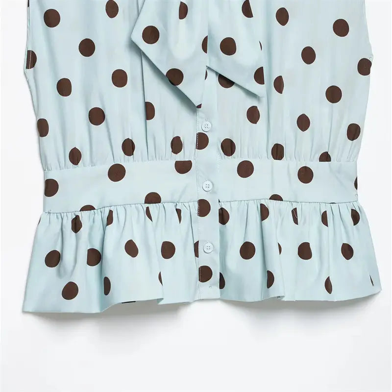 Mid waist closeup, elastic gathered smocked waistband, layered peplum ruffle hem, front vertical button placket