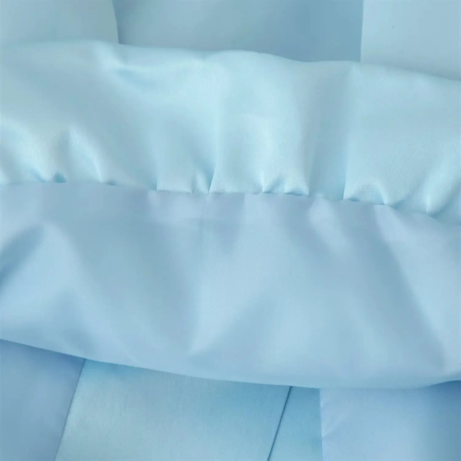 Peplum hem inner lining partial shot, matching light blue satin lining, folded hem overlock stitching