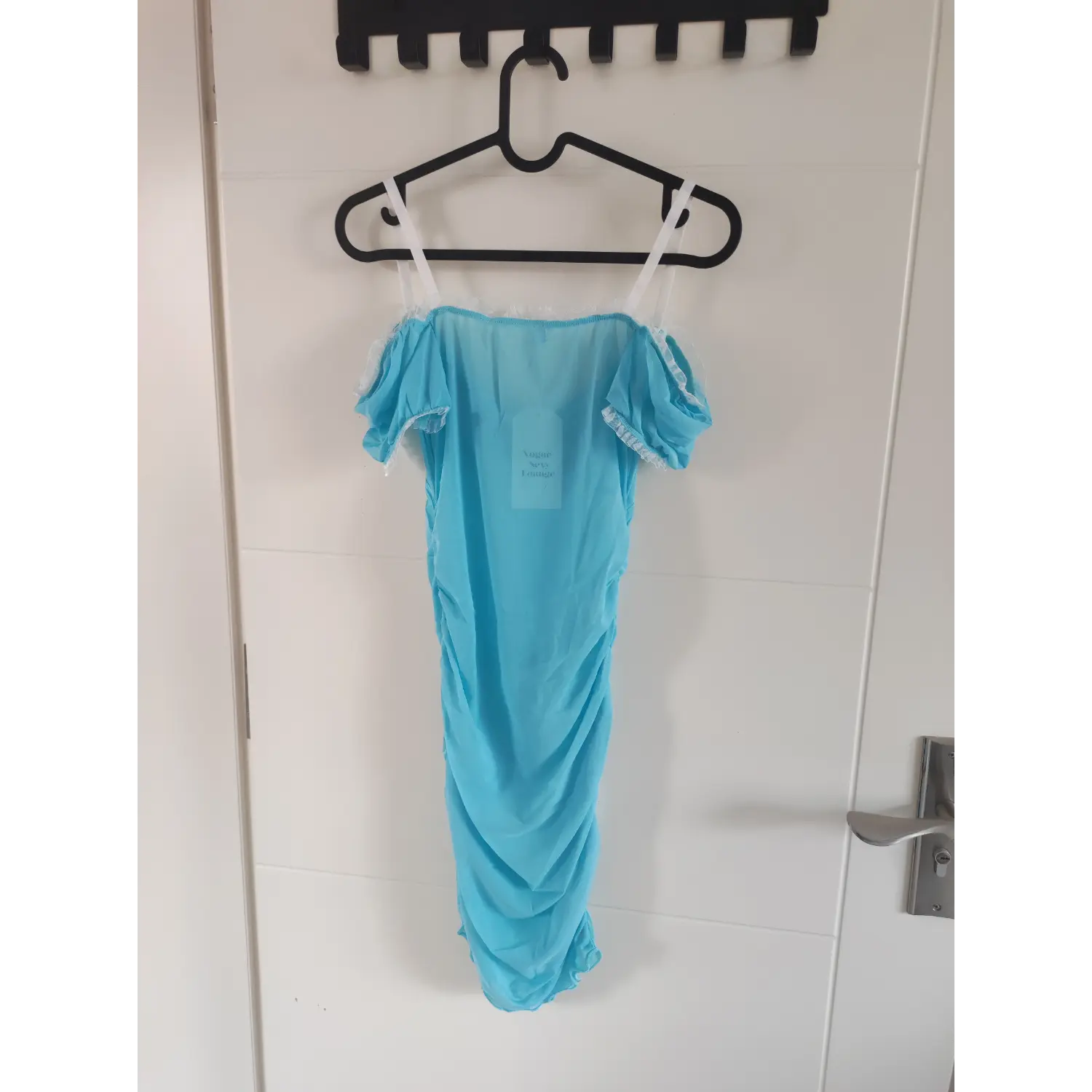Back view shot of light blue off shoulder sheer mesh mini dress, smooth back panel, puff short sleeves, hanging on hanger