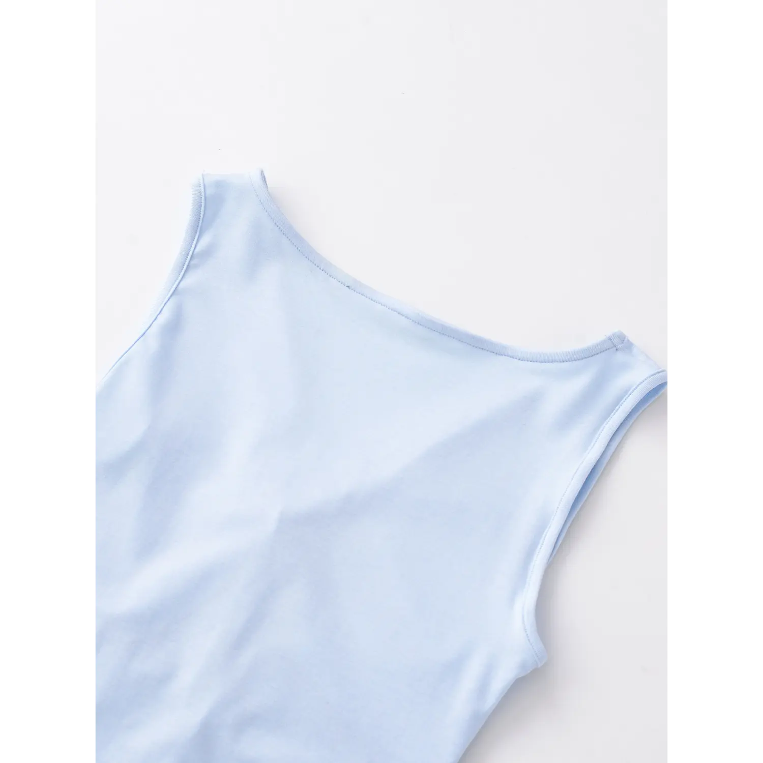 Light blue sleeveless tank back neck flat close-up, crew neck neat binding overlock stretch knit smooth fabric stitching white background shot