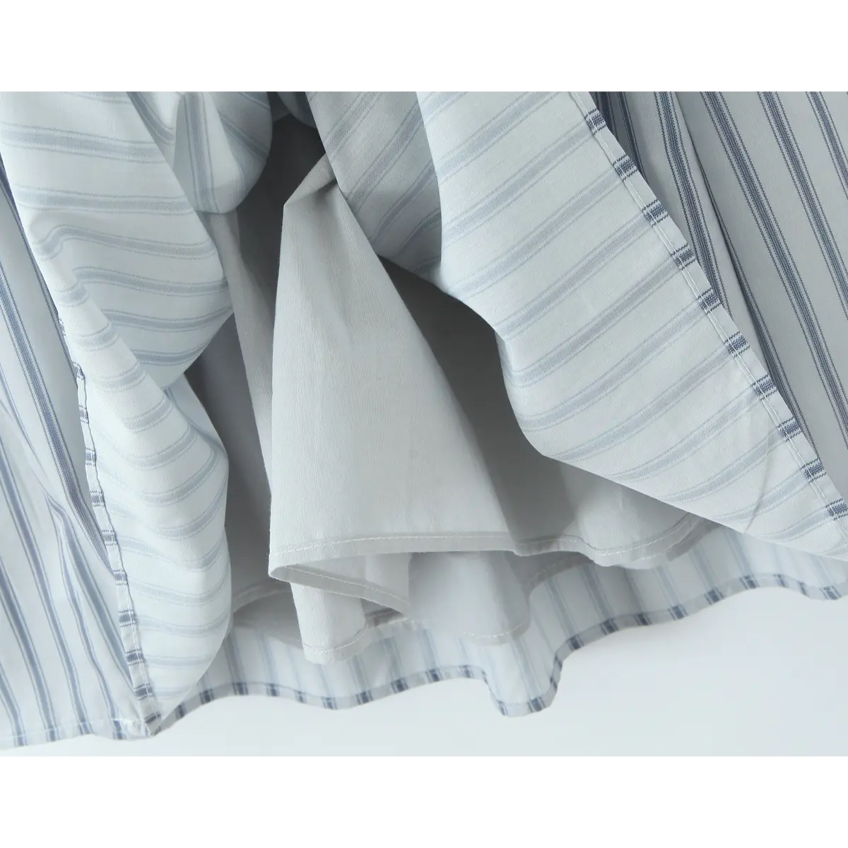Close-up of the dress lining, showing the inner construction and fabric layers of the light blue striped halter dress.