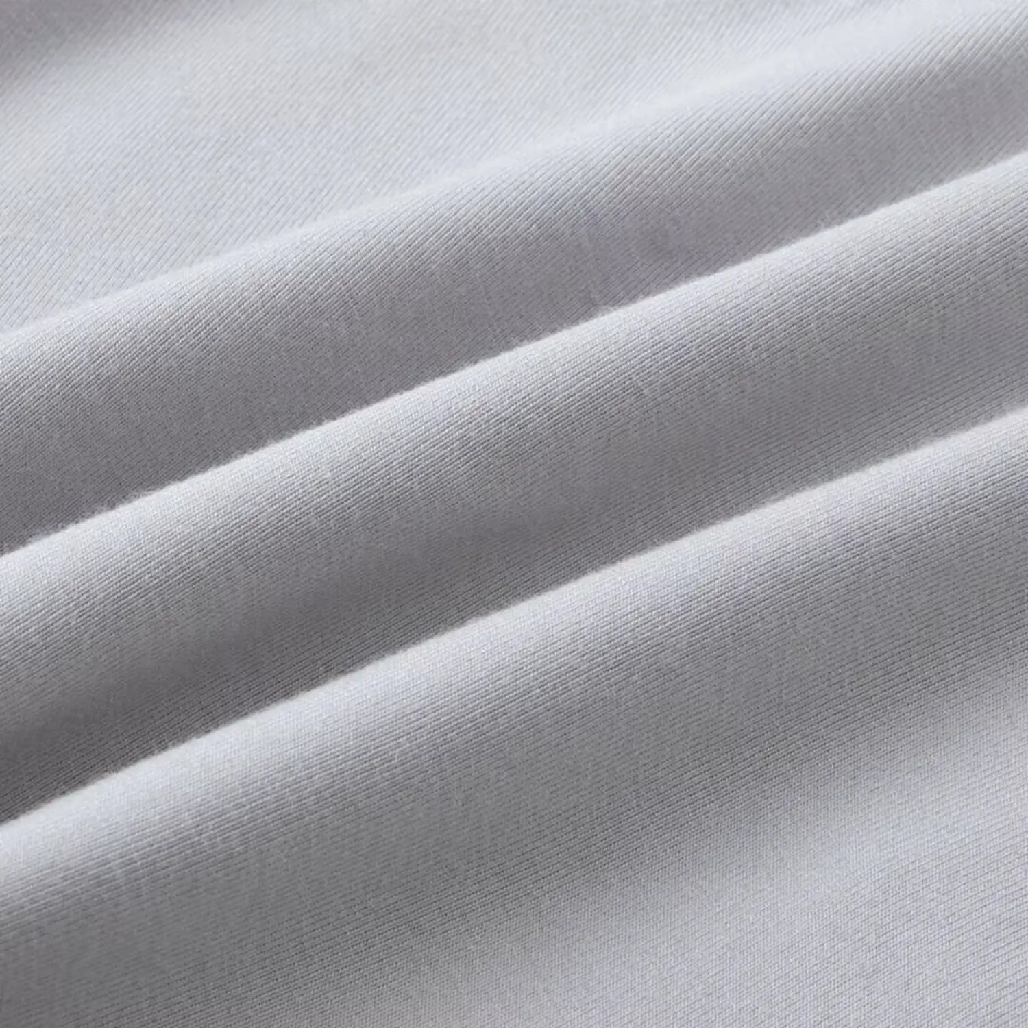 Texture close‑up showing soft ribbed knit fabric of light gray halter camisole top