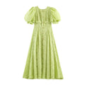 Front view of light green jacquard maxi dress, round neck, puff short sleeves, decorative gold rose buttons, fitted waist and flowy long skirt