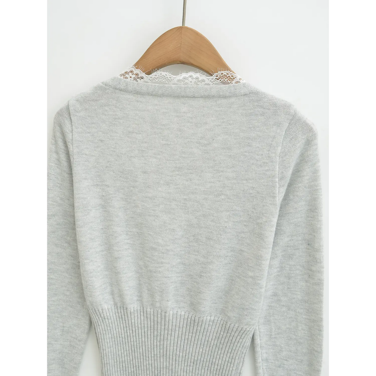 Full back view of light grey knit cardigan, delicate lace trimming on rear neckline, ribbed fitted waist
