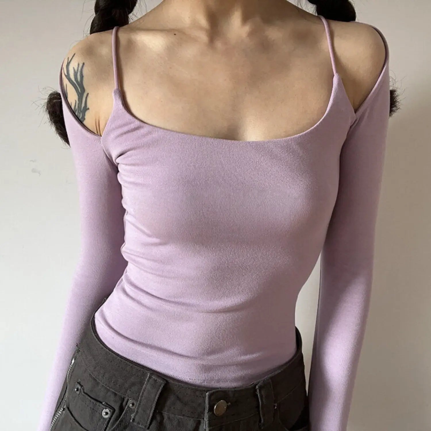 Light lilac spaghetti strap fake two piece cold shoulder long sleeve top half body indoor shot, slim waist cropped stretch knit square cold shoulder soft pastel girly daily inner top