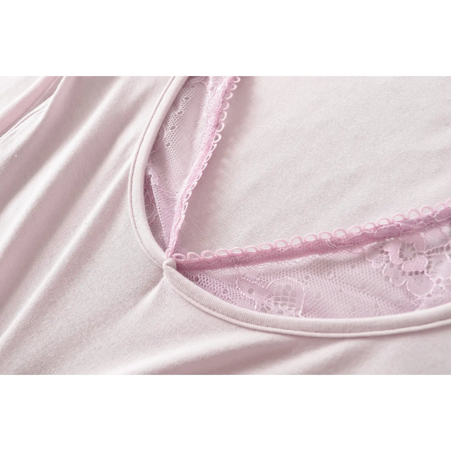 Light lilac fake two piece long sleeve top u neck macro flat close-up, scalloped lace spaghetti straps double binding reinforced stitching wide u neck neat overlock knit fabric white background detail shot