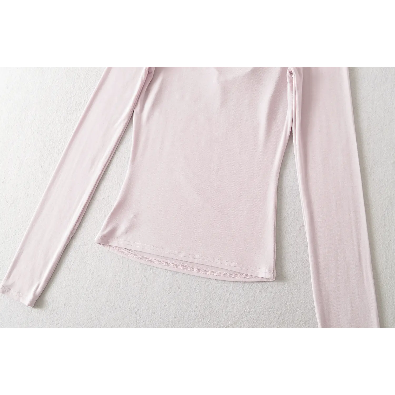 Light lilac fake two long sleeve top side waist flat close-up, stretch knit natural ruched slim waist cut hem wavy overlock white background shot