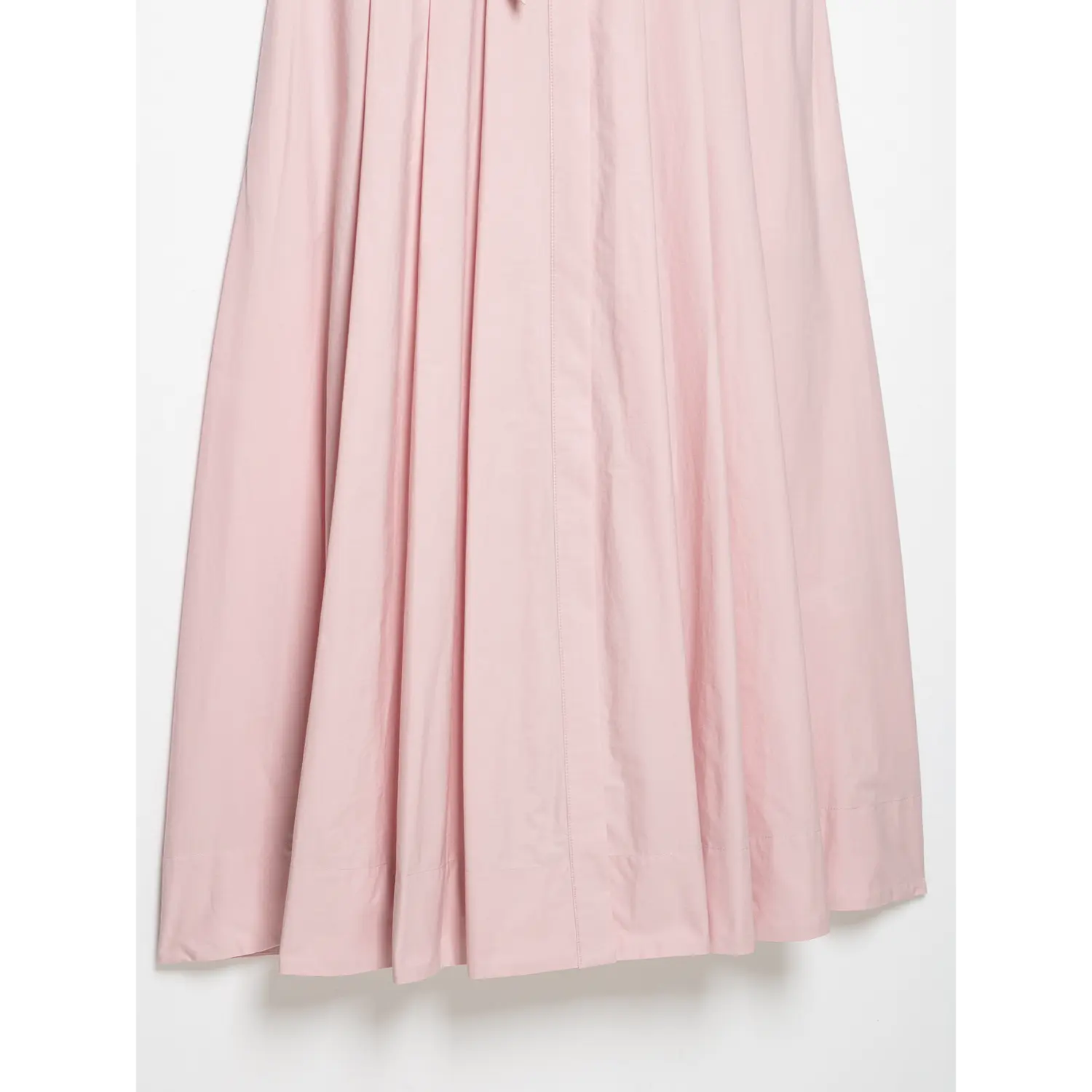 Wide partial shot of full vertical pleated A-line skirt, structured flared silhouette
