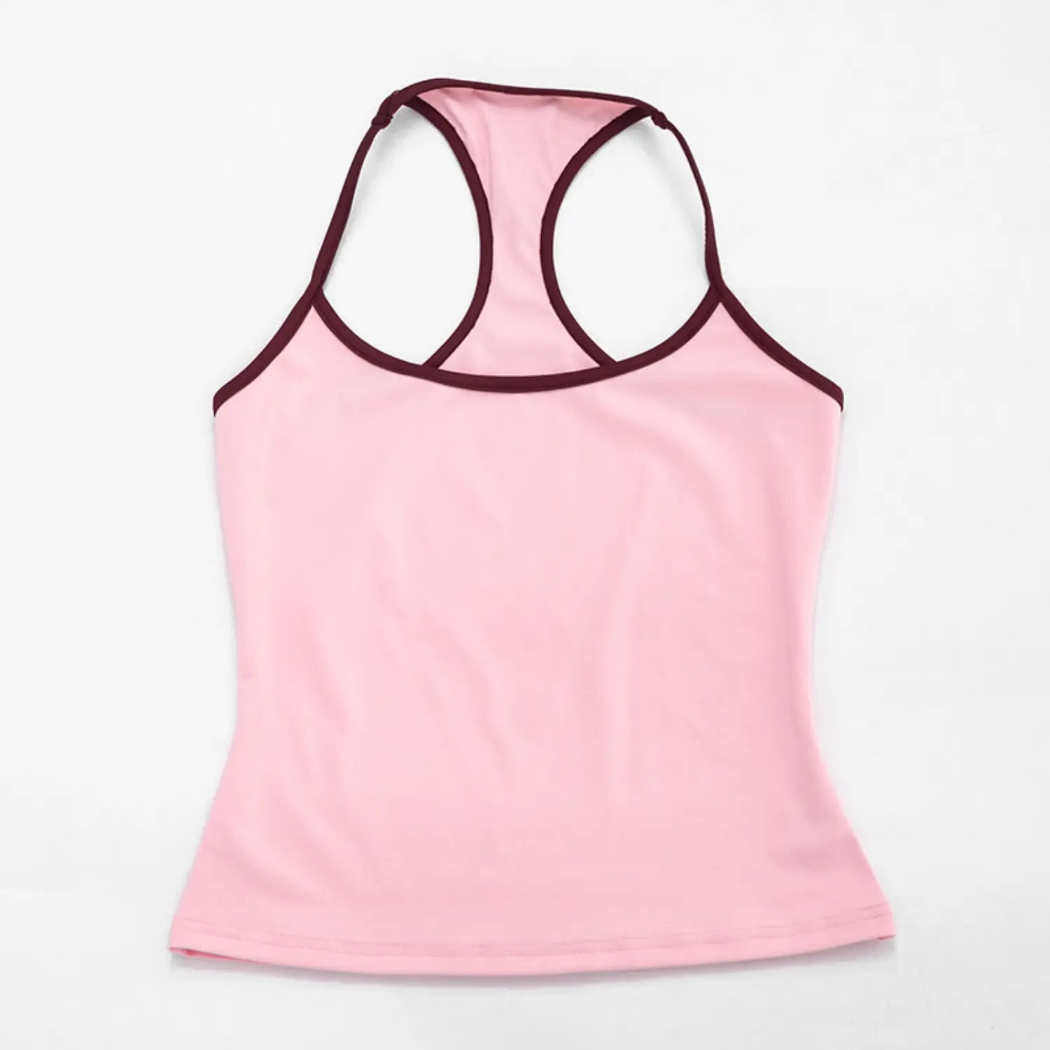 Full flat lay studio shot of racerback halter crop tank top on plain white background, solid baby pink body with burgundy contrast piping trim, slim fitted waist silhouette, double thin halter straps forming rear cutout shape