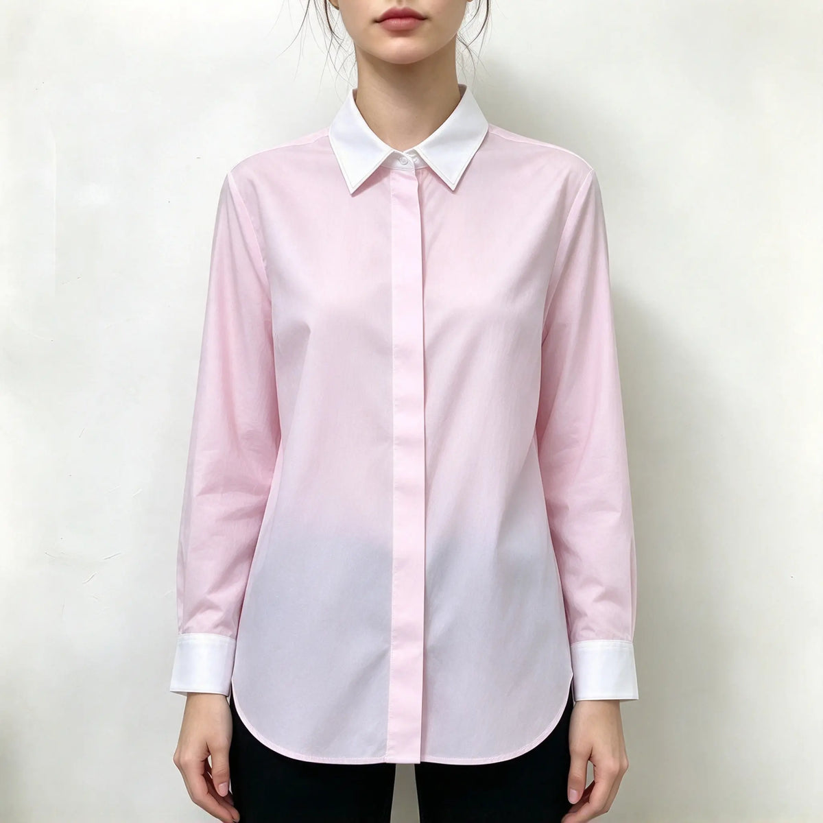 Model wearing light pink contrast collar cuff button front shirt with black pants, front view