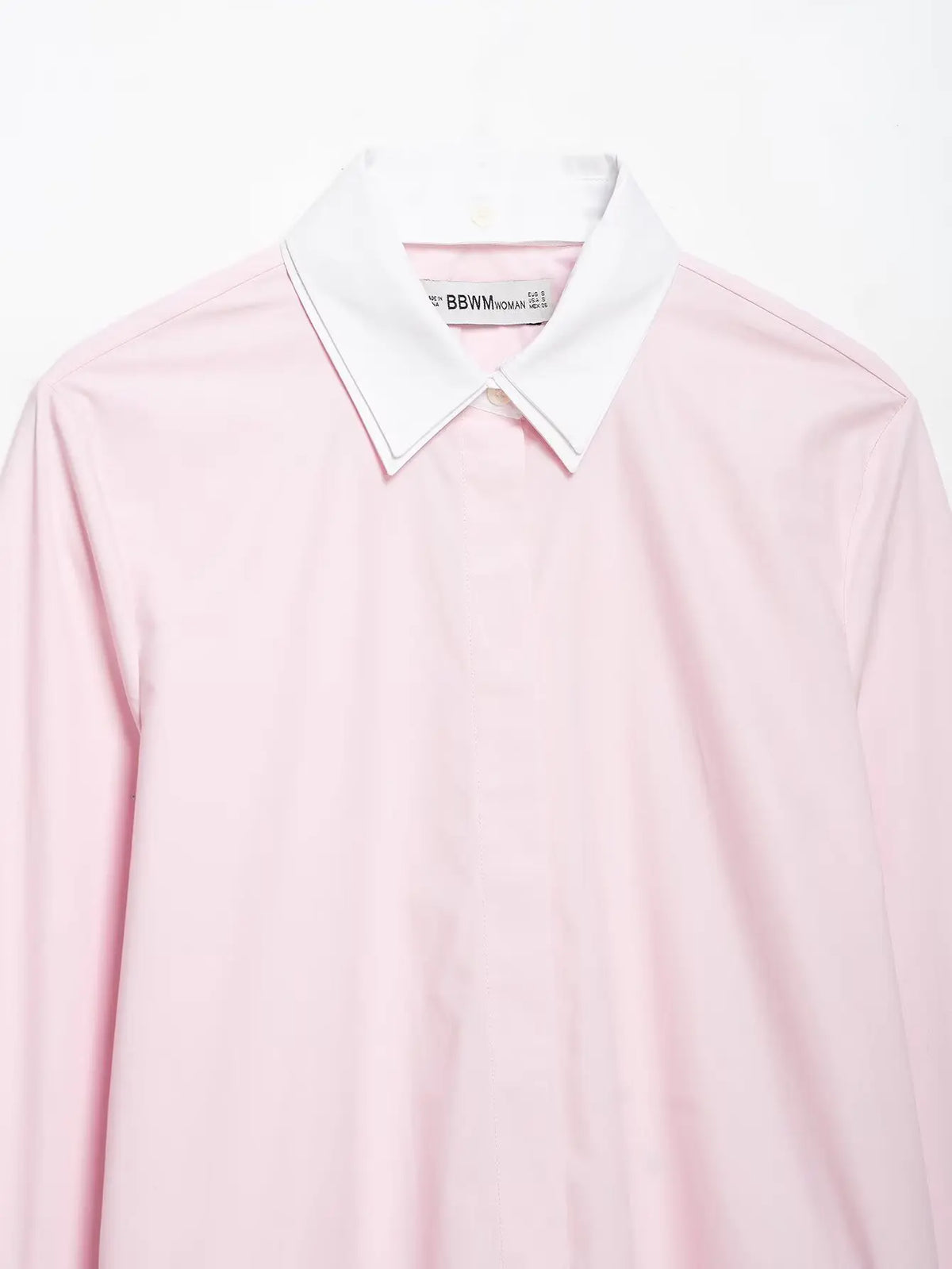 Close-up of white pointed collar and hidden placket