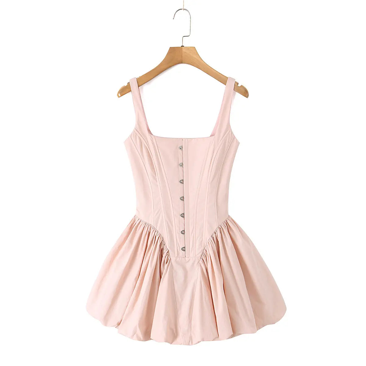 Front view of a light pink corset dress with metal eyelet details and a bubble hem.

