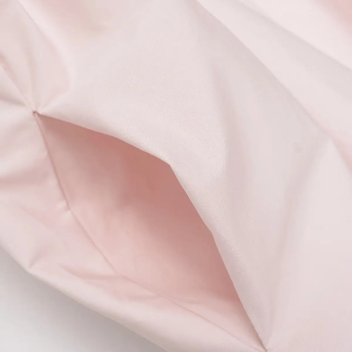 Close-up of the side pocket on the light pink cotton dress, showing the hidden opening and matching lining