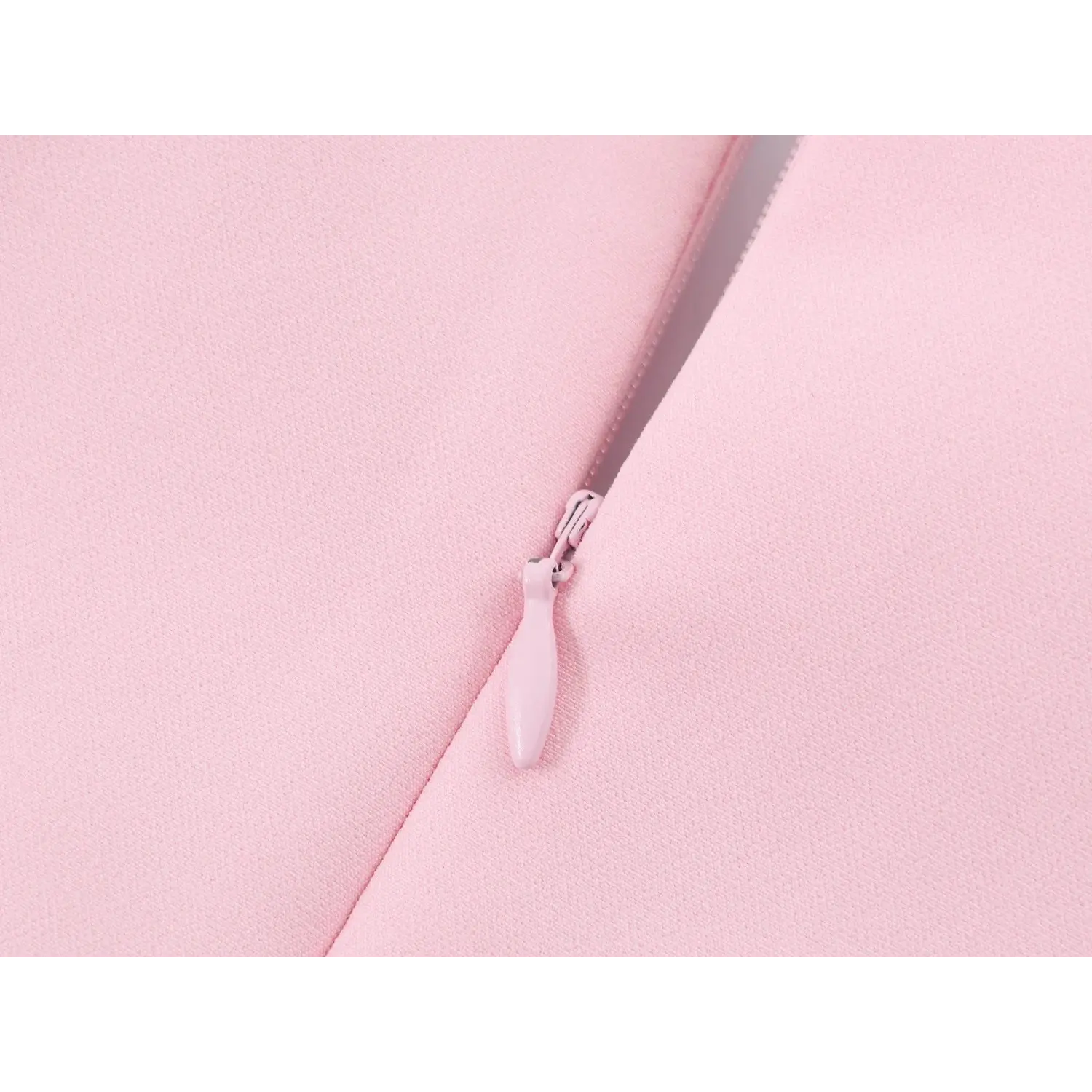 Back center invisible zipper pull tab close-up, pink coated zipper hardware, aligned back vertical seam
