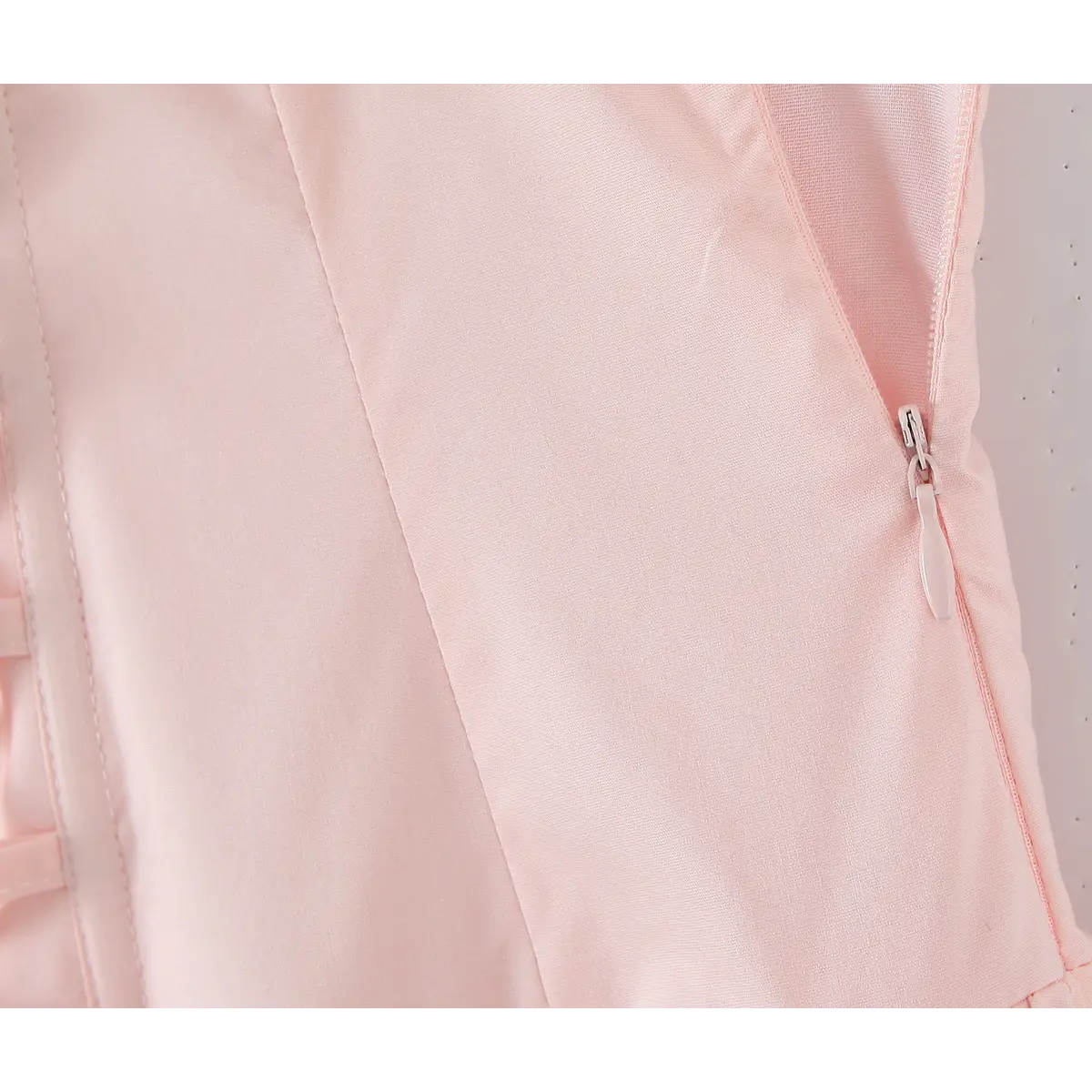 Close-up of the side zipper on a light pink halter maxi dress, showing the invisible zipper closure.
