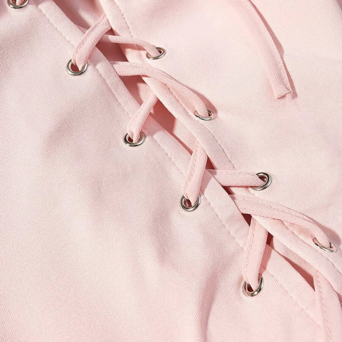 Close-up of metal eyelets and lace up back