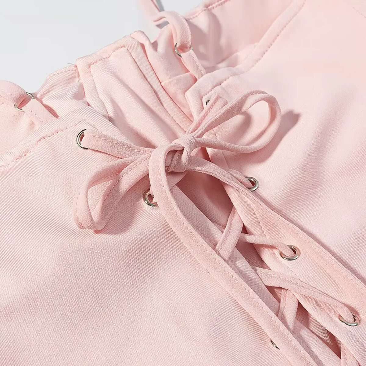 Close-up of crisscross lace up back and metal eyelets