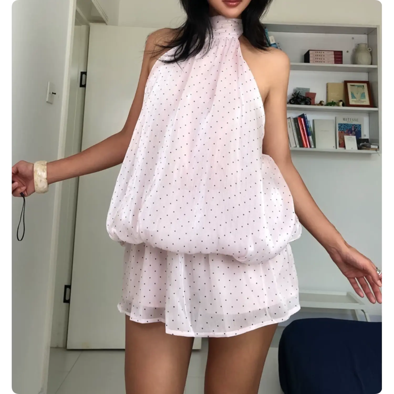Light pink polka dot halter bubble mini dress casual arm spread pose