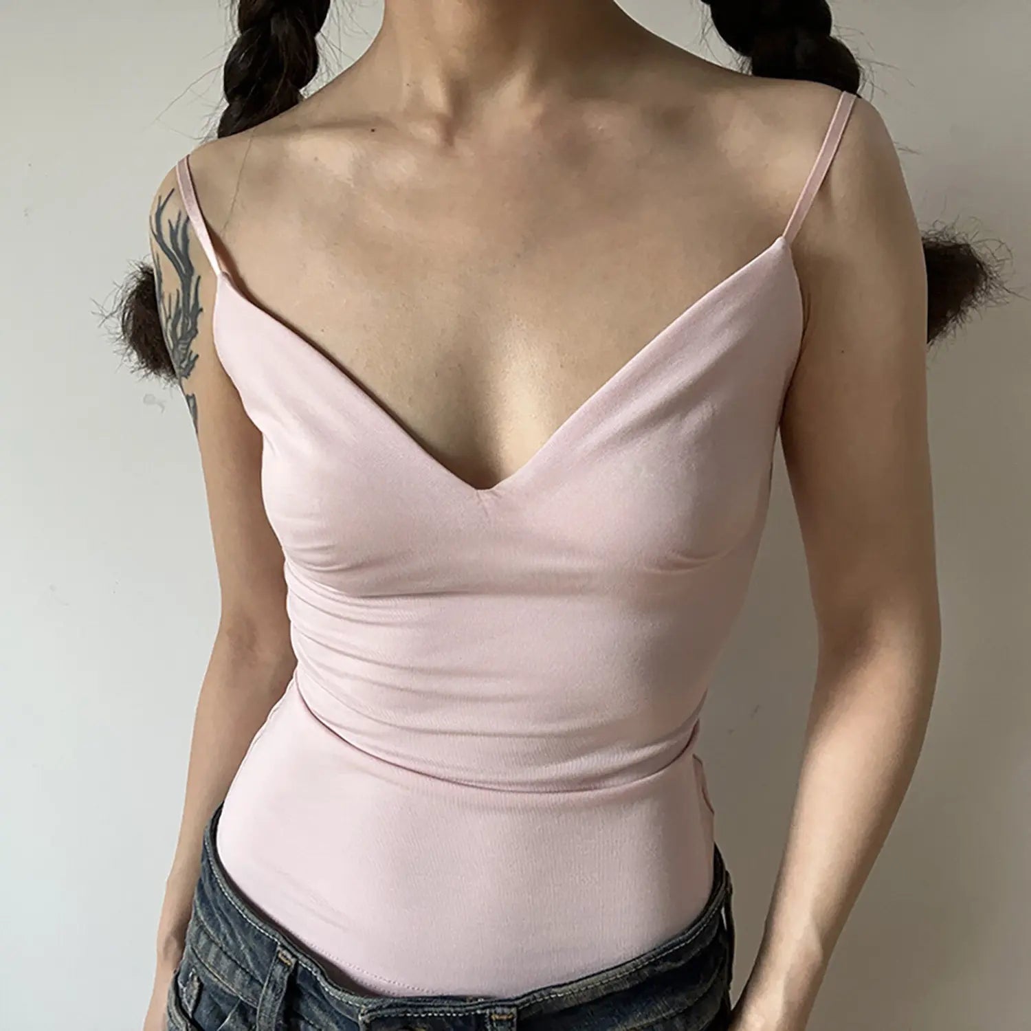 Women soft light pink stretch camisole tank top front view, deep V neck ruched waist fitted thin adjustable straps basic everyday inner wear