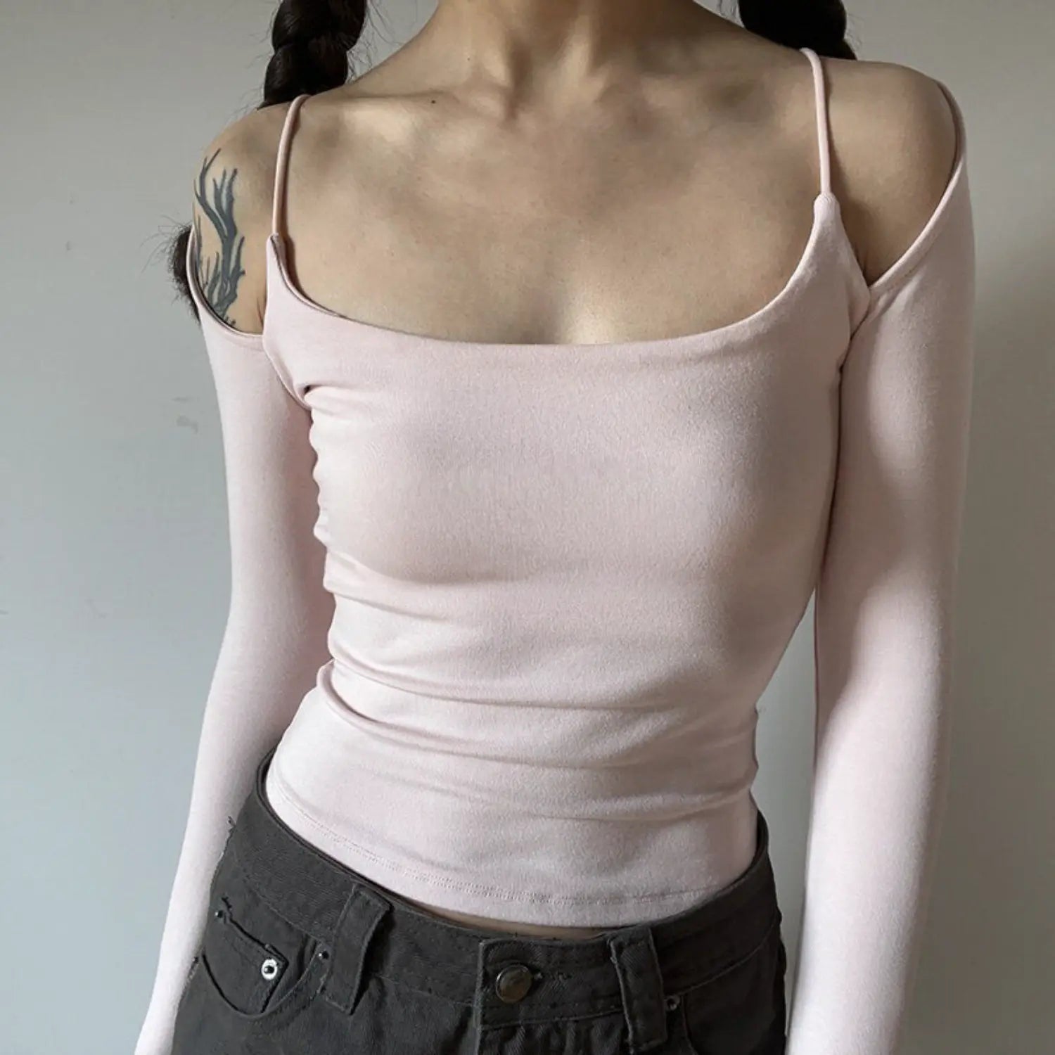 Light pink spaghetti strap off shoulder long sleeve top half body indoor shot, stretch knit slim cropped fit, sweet girly fresh soft daily inner top