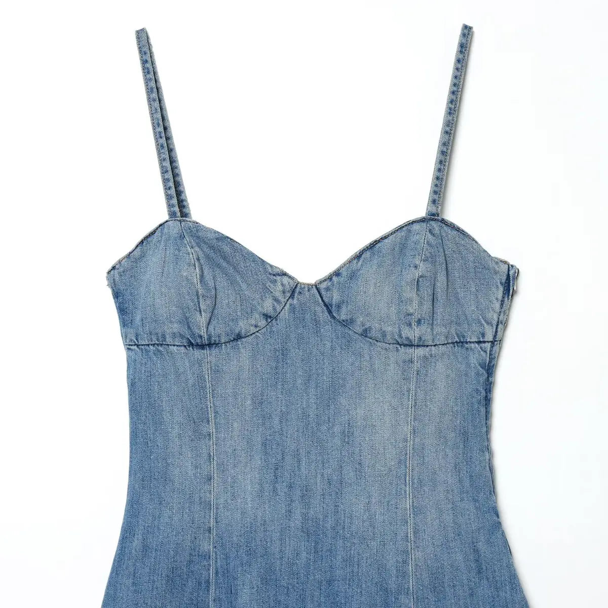 Front view of light wash denim spaghetti strap dress, showing the sweetheart bustier top and vertical seams