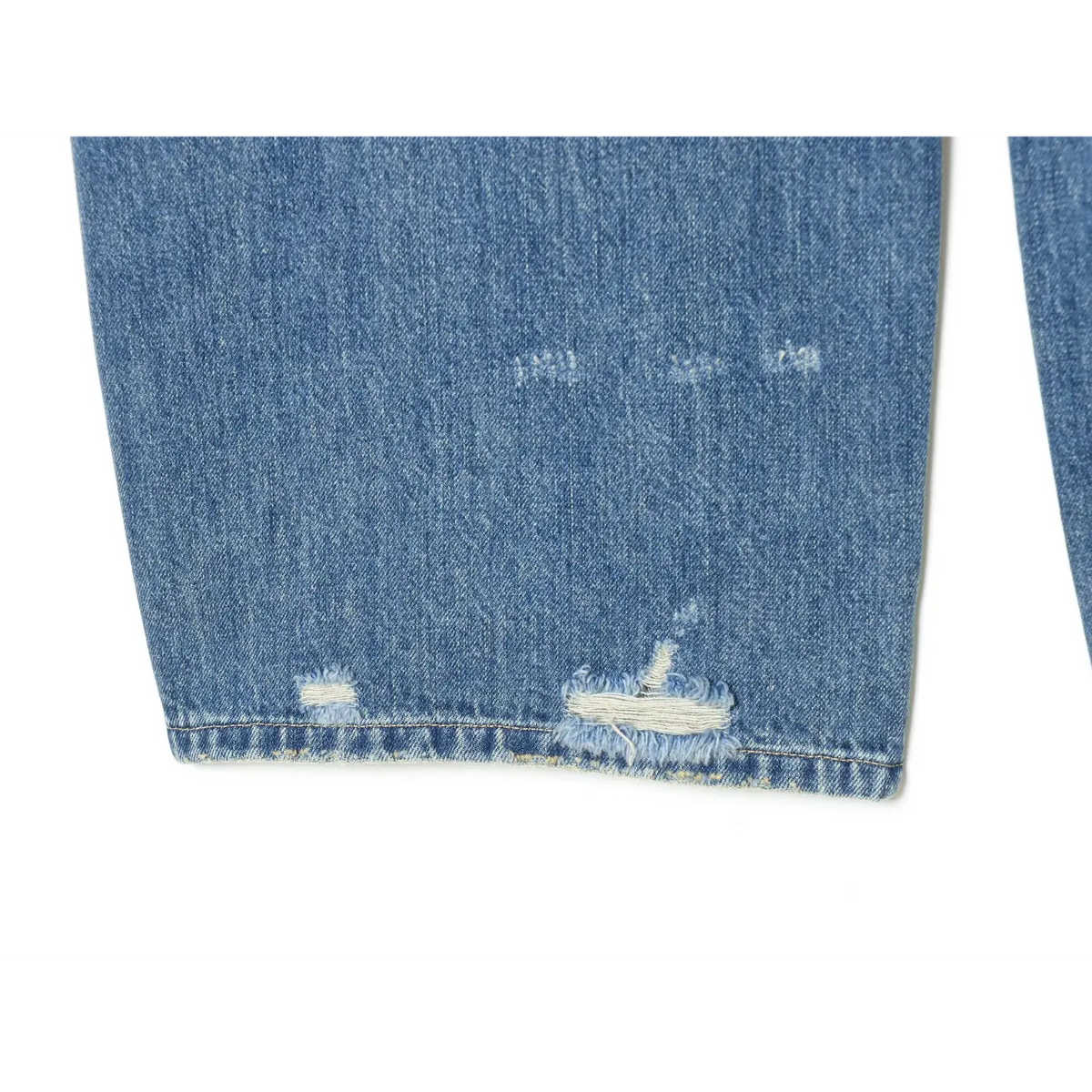 Close-up of frayed distressed hem at leg opening