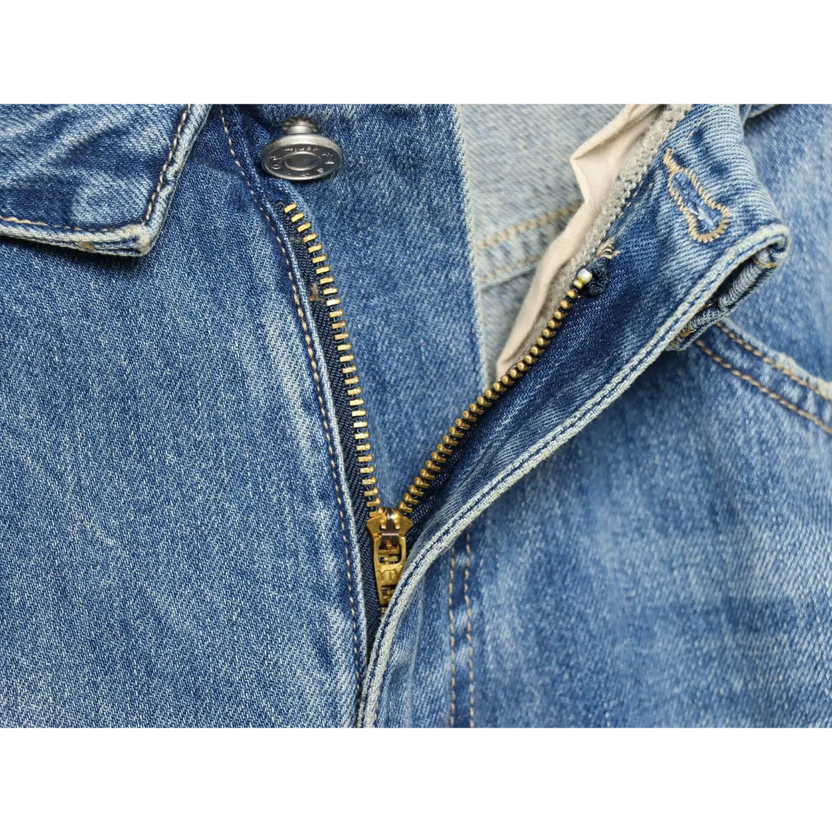 Close-up of brass zip fly and metal shank button